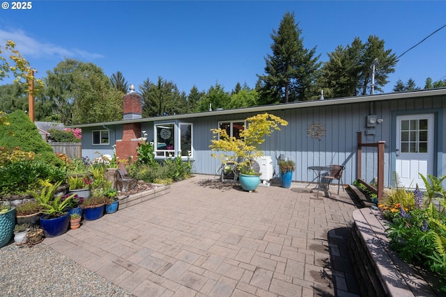 90726 Sanddollar Ln, Coos Bay, OR 97420 - rear view of property with a patio and a chimney