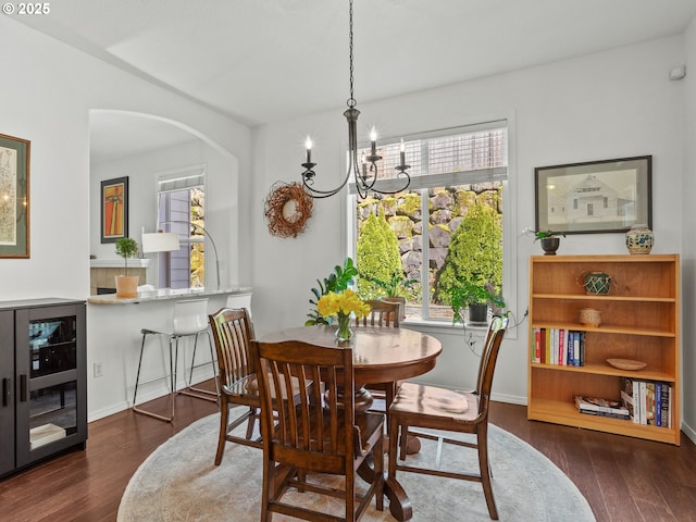 5417 N St, Washougal, WA 98671 - dining area featuring beverage cooler, dark wood-type flooring, arched walkways, and a chandelier