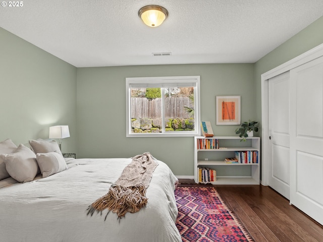 5417 N St, Washougal, WA 98671 - bedroom featuring wood finished floors, a closet, a textured ceiling, and baseboards