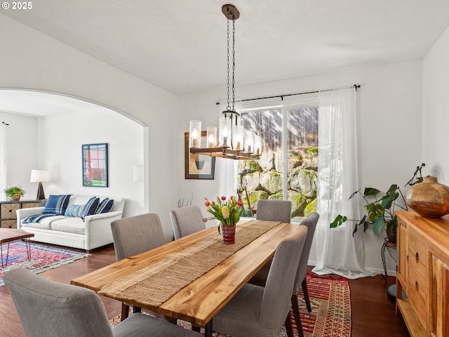 5417 N St, Washougal, WA 98671 - dining room featuring a chandelier, arched walkways, and dark wood-style flooring