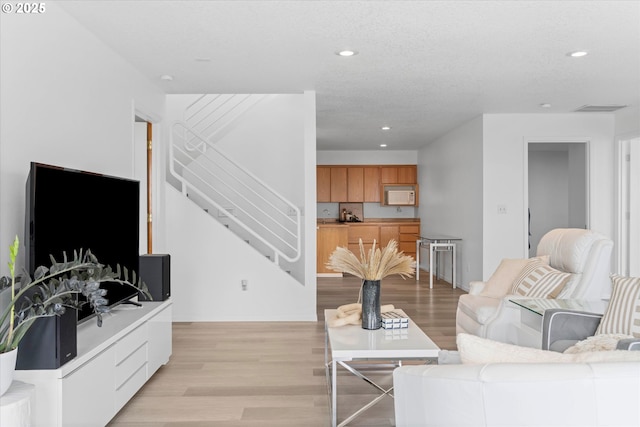 27917 NE 67th St, Camas, WA 98607 - living area with stairs, light wood-style flooring, recessed lighting, and baseboards