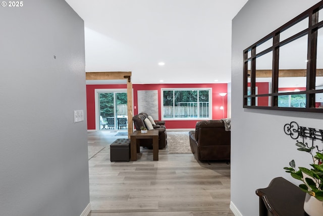 corridor featuring baseboards, recessed lighting, and wood finished floors