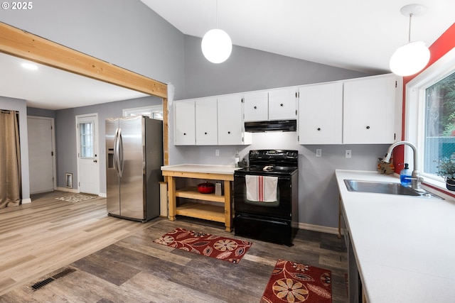 kitchen with visible vents, black electric range oven, under cabinet range hood, stainless steel fridge with ice dispenser, and a sink