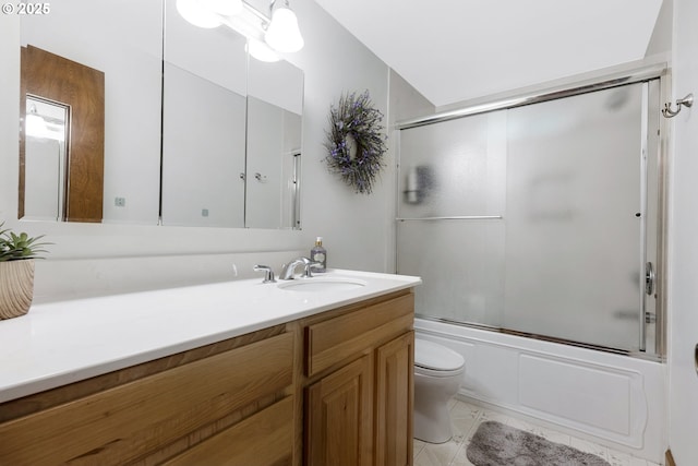 full bathroom featuring toilet, enclosed tub / shower combo, tile patterned flooring, and vanity