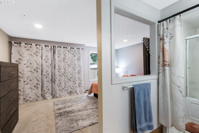 ensuite bathroom featuring recessed lighting, a shower with door, and ensuite bathroom