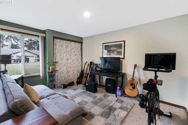 living room featuring carpet flooring and baseboards