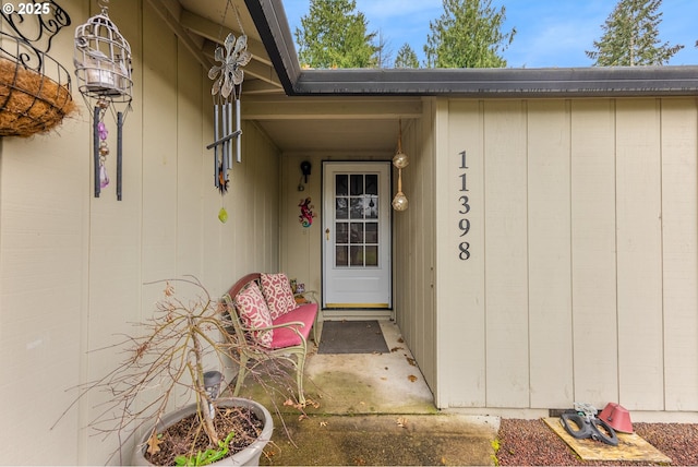 property entrance featuring board and batten siding