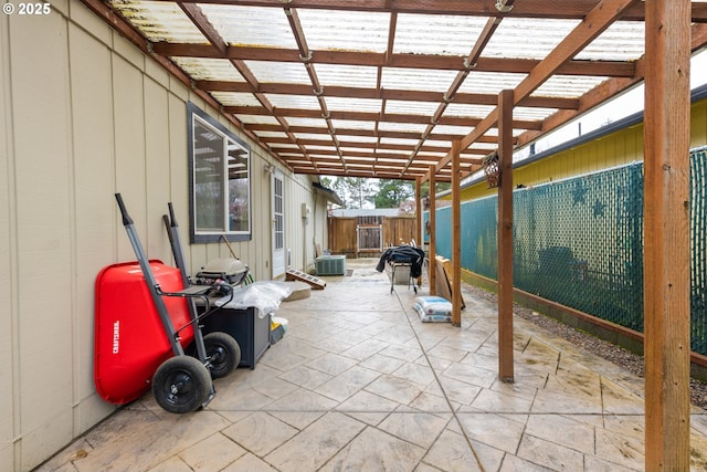 view of patio / terrace with central air condition unit and fence