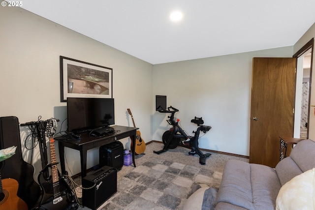 exercise room featuring baseboards and carpet