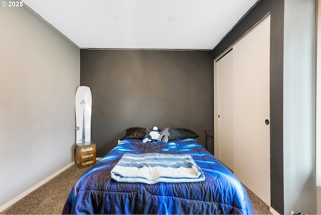 bedroom with baseboards and carpet