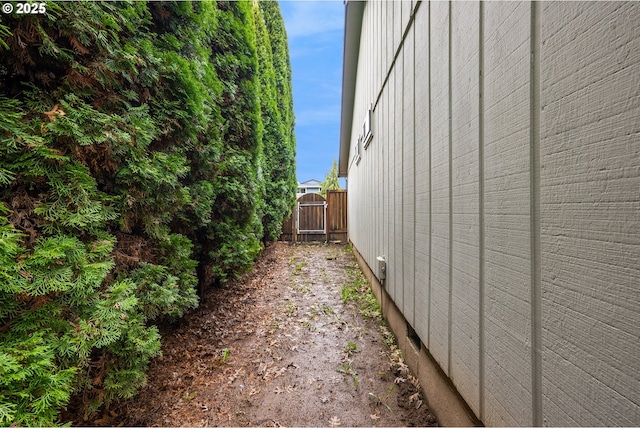 view of home's exterior with fence and a gate