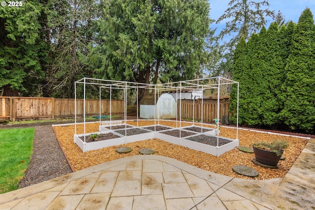 exterior space with a storage shed, an outdoor structure, a fenced backyard, and a vegetable garden