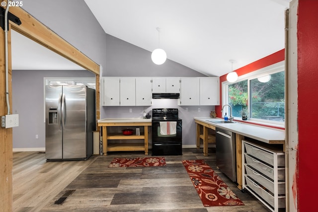 kitchen with a sink, under cabinet range hood, stainless steel appliances, white cabinets, and lofted ceiling