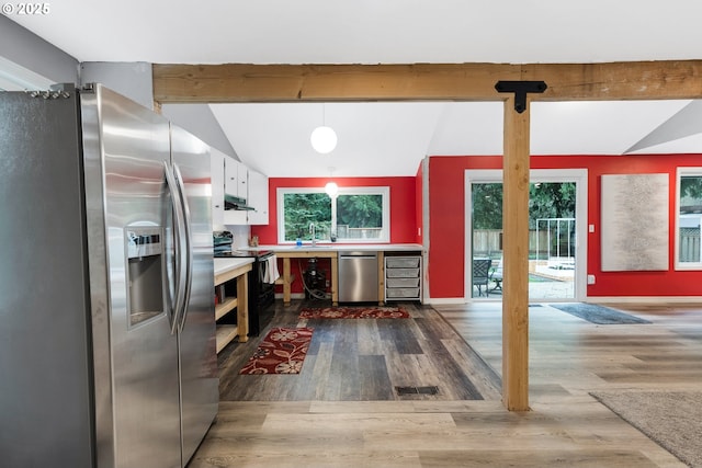 kitchen with lofted ceiling with beams, under cabinet range hood, dark wood-style floors, white cabinetry, and appliances with stainless steel finishes