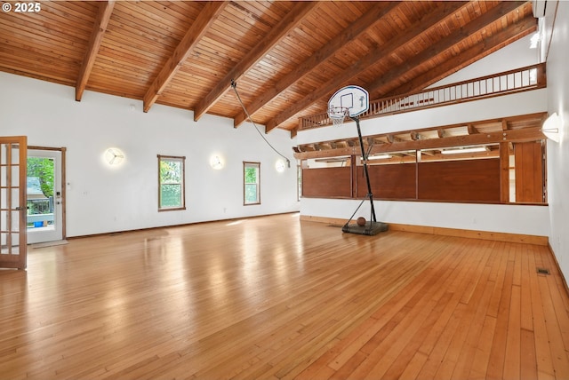 interior space with beam ceiling, high vaulted ceiling, hardwood / wood-style floors, baseboards, and wooden ceiling