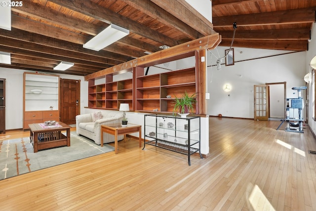 living area featuring baseboards, wood ceiling, beam ceiling, and hardwood / wood-style floors