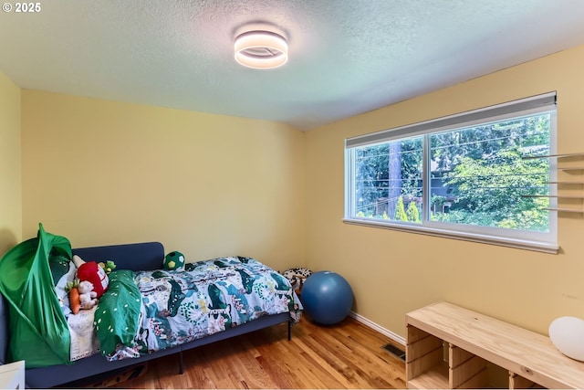 7680 SW 92nd Pl, Portland, OR 97223 - bedroom with baseboards, wood finished floors, and a textured ceiling