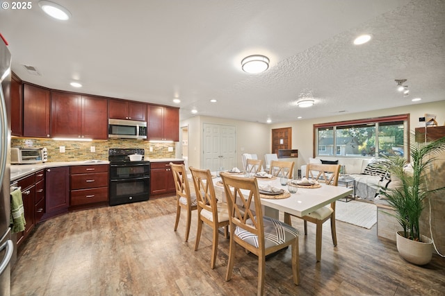 dining room featuring hardwood / wood-style floors and a textured ceiling