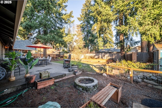 view of yard featuring a patio and an outdoor fire pit