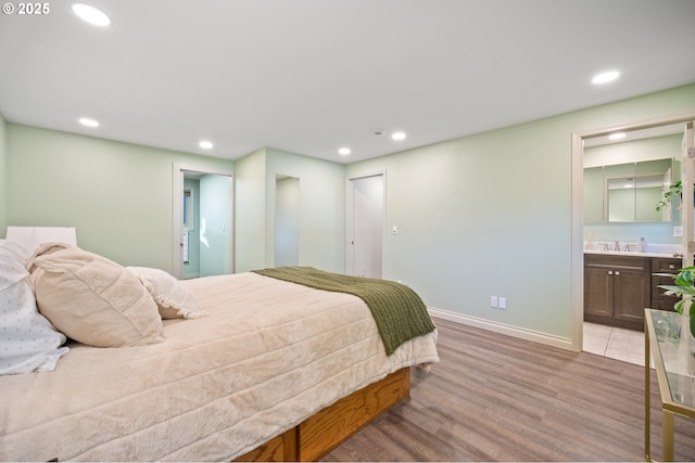 bedroom featuring light wood-type flooring and ensuite bathroom