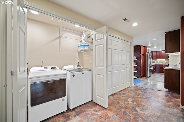 clothes washing area featuring washer and dryer