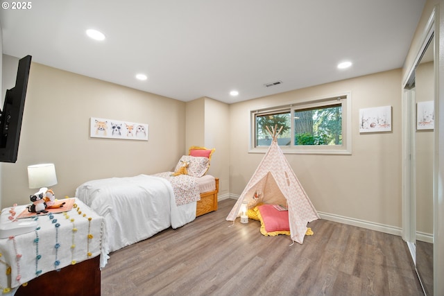 bedroom with hardwood / wood-style floors