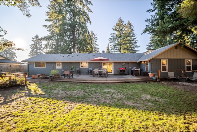 rear view of house featuring a patio area and a yard