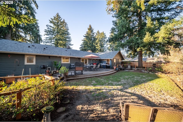 rear view of house featuring a yard