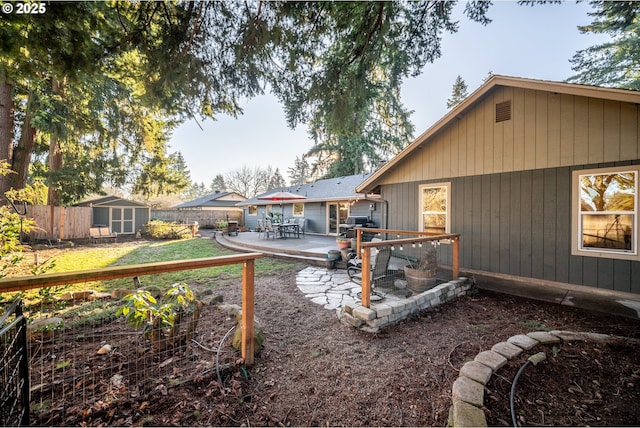 view of yard featuring a storage shed and a patio