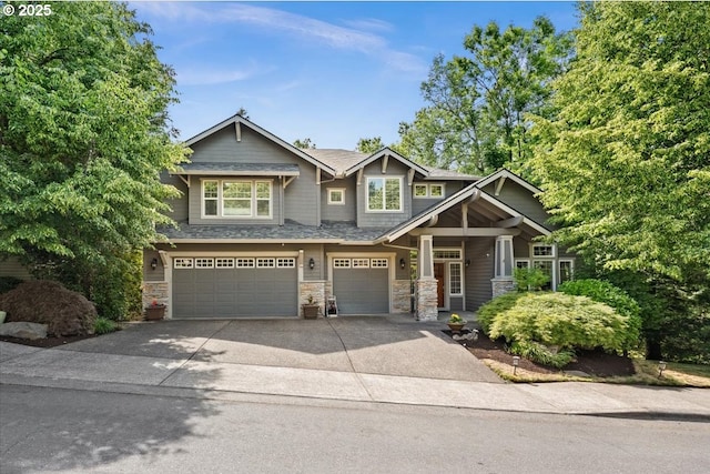 711 NW 94th Ter, Portland, OR 97229 - craftsman-style house with a garage, driveway, stone siding, and a porch