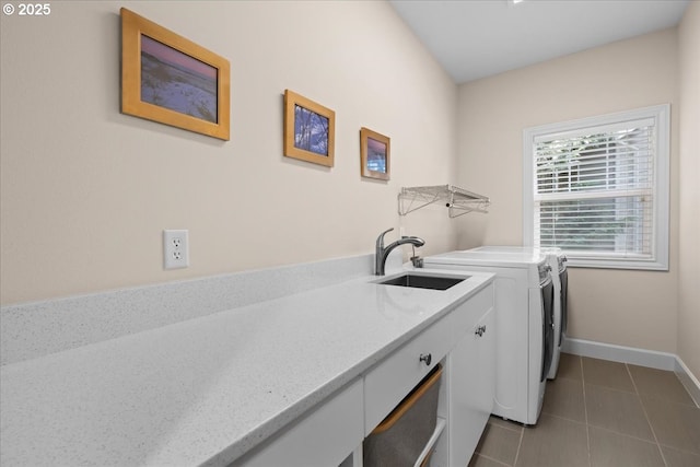 711 NW 94th Ter, Portland, OR 97229 - laundry room with washing machine and dryer, dark tile patterned flooring, and cabinet space