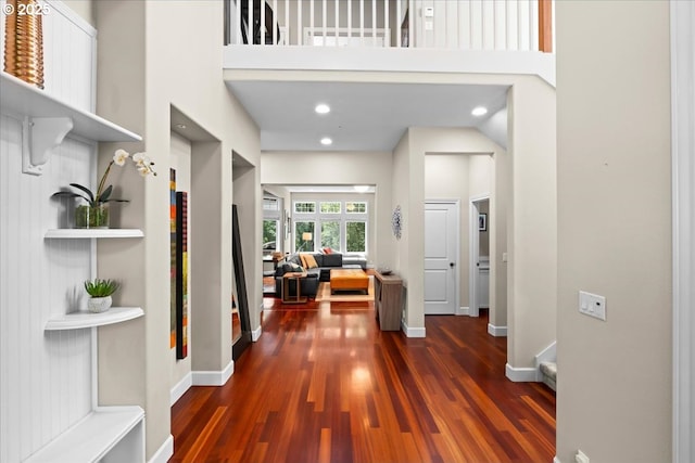 711 NW 94th Ter, Portland, OR 97229 - hall featuring dark wood-type flooring, a high ceiling, and recessed lighting