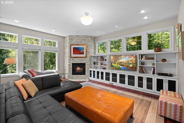711 NW 94th Ter, Portland, OR 97229 - living area with healthy amount of natural light, a fireplace, recessed lighting, and wood finished floors