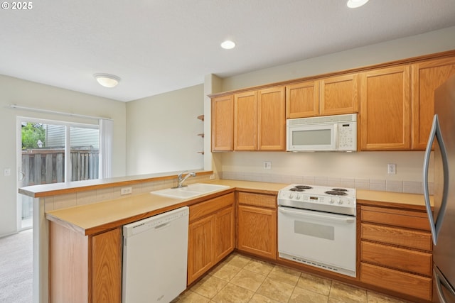 6538 NE Forest Ln, Hillsboro, OR 97124 - kitchen with white appliances, a peninsula, light countertops, and recessed lighting
