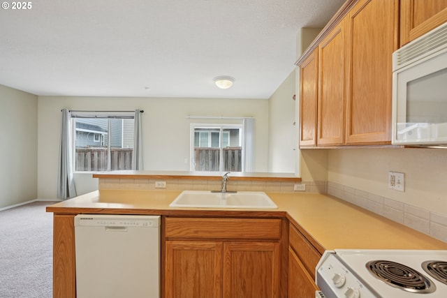 6538 NE Forest Ln, Hillsboro, OR 97124 - kitchen featuring white appliances, a peninsula, carpet floors, light countertops, and tasteful backsplash
