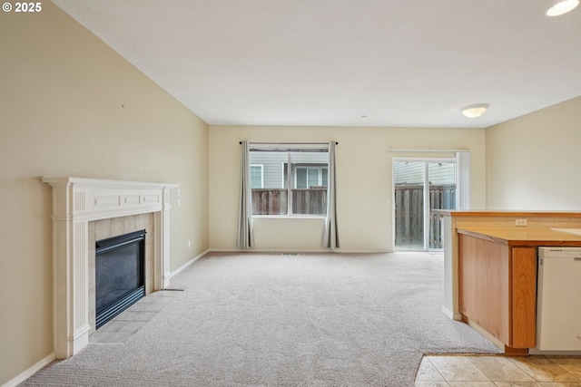 6538 NE Forest Ln, Hillsboro, OR 97124 - unfurnished living room with light carpet and a tiled fireplace