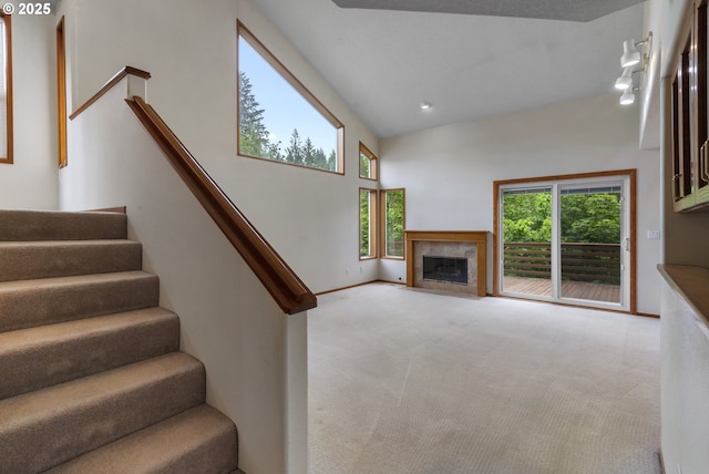 15917 NE Union Rd, Ridgefield, WA 98642 - staircase with carpet floors, plenty of natural light, a fireplace with flush hearth, and baseboards