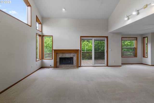 15917 NE Union Rd, Ridgefield, WA 98642 - unfurnished living room with carpet floors, a tiled fireplace, and baseboards