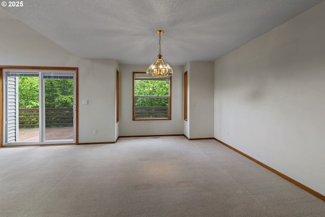 15917 NE Union Rd, Ridgefield, WA 98642 - empty room featuring a chandelier, baseboards, light carpet, and a textured ceiling