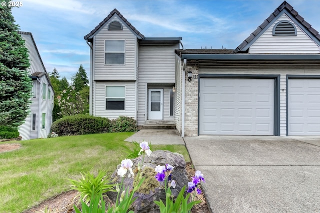 15917 NE Union Rd, Ridgefield, WA 98642 - view of front facade featuring concrete driveway, a garage, brick siding, and a front yard