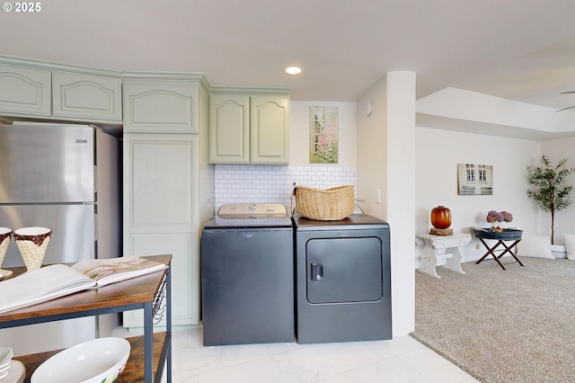 laundry room featuring washer and dryer and light colored carpet