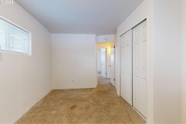 unfurnished bedroom with carpet and a closet