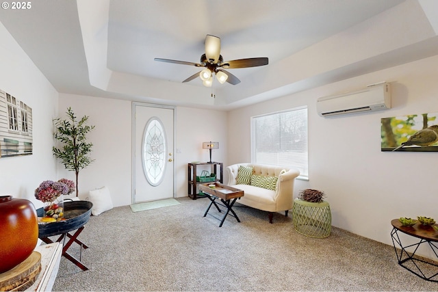 foyer with ceiling fan, a wall mounted AC, a raised ceiling, and carpet