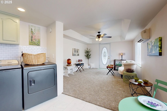 interior space featuring light carpet, ceiling fan, a wall mounted air conditioner, and washing machine and clothes dryer