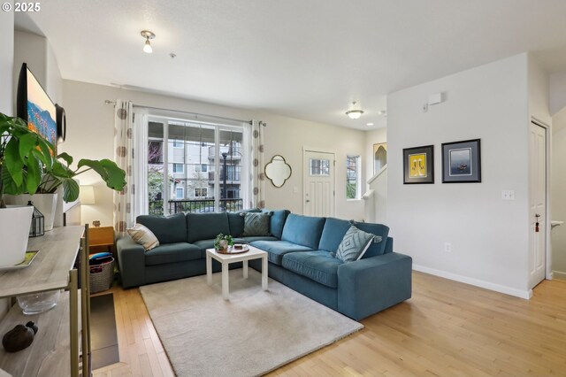 605 NW Lost Springs Ter Unit 102, Portland, OR 97229 - living room with light wood-style floors and baseboards