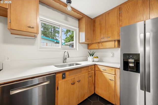 12405 SW Faircrest St, Portland, OR 97225 - kitchen featuring appliances with stainless steel finishes, light countertops, dark tile patterned floors, and brown cabinets