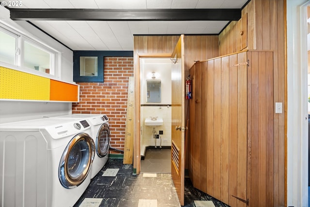 12405 SW Faircrest St, Portland, OR 97225 - laundry area with electric panel, wood walls, brick wall, and washer and dryer