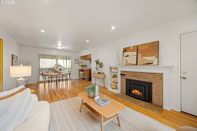 12405 SW Faircrest St, Portland, OR 97225 - living room with wood finished floors, a brick fireplace, and recessed lighting