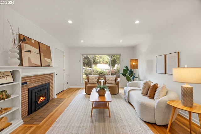 12405 SW Faircrest St, Portland, OR 97225 - living area featuring light wood finished floors, a brick fireplace, and recessed lighting