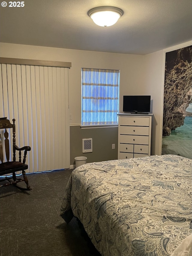 bedroom with carpet floors and a textured ceiling